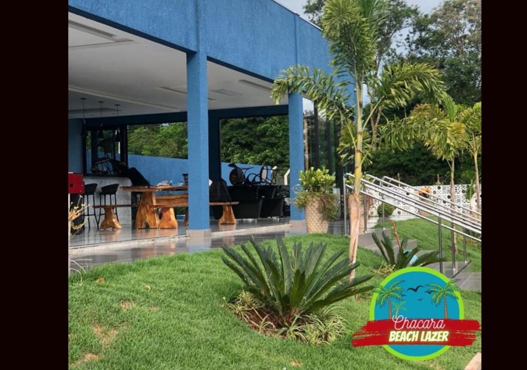 un edificio azul con una palmera en un patio en Chacara Beach Lazer, en Foz do Iguaçu
