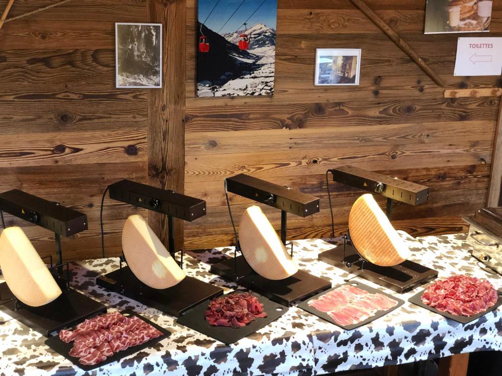 a table with a bunch of plates of food at L'Escale (accès en télécabine) in Châtel