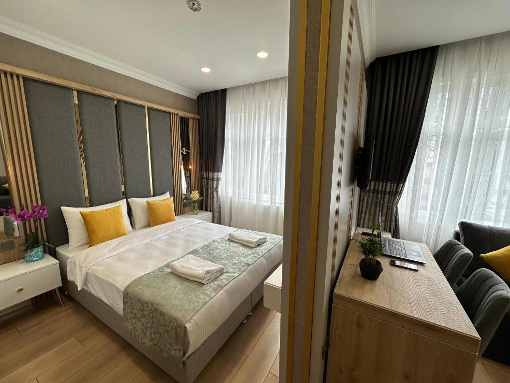 a bedroom with a bed and a desk at H&L Suites in Istanbul