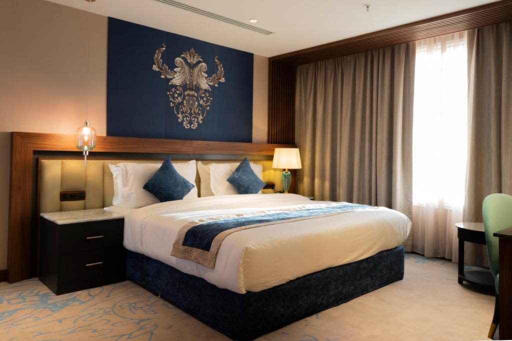 Postel nebo postele na pokoji v ubytování Najm aris hotel