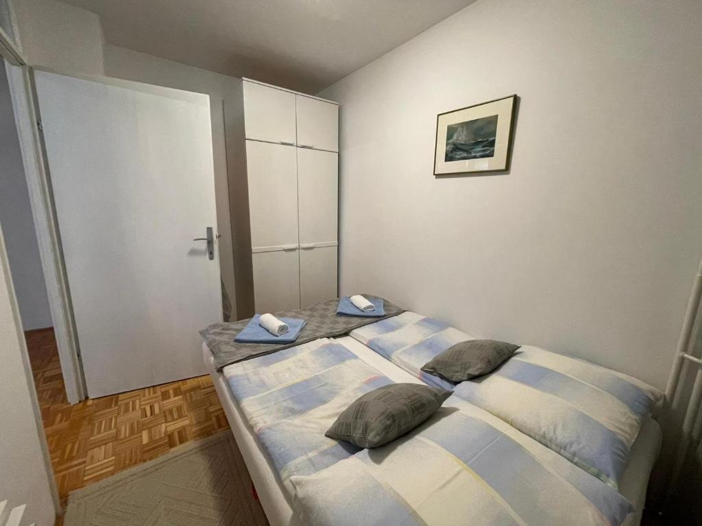 a bedroom with a bed with two pillows on it at Ami-go/ Blizu zračne luke Zagreb in Velika Gorica