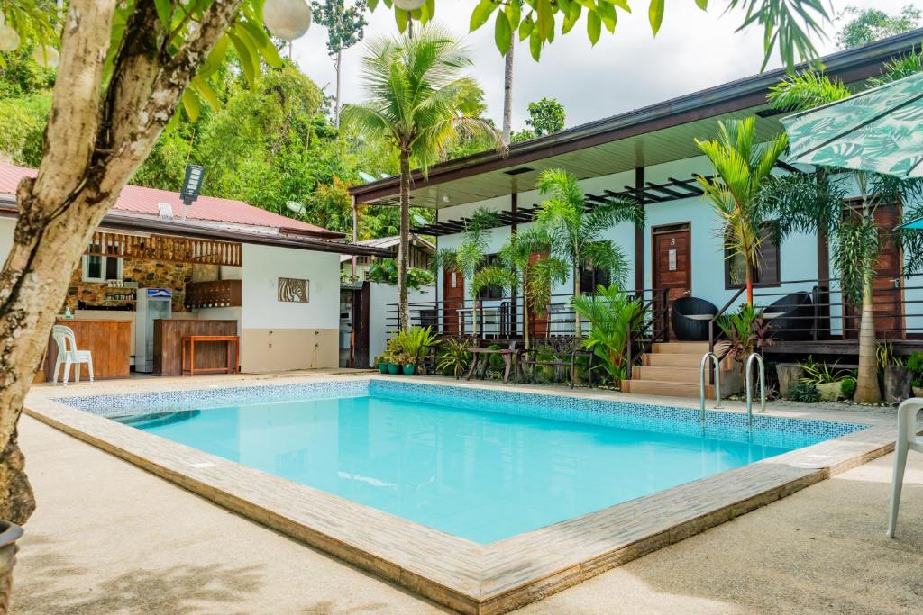 a swimming pool in front of a house at Teteng's Home in San Vicente