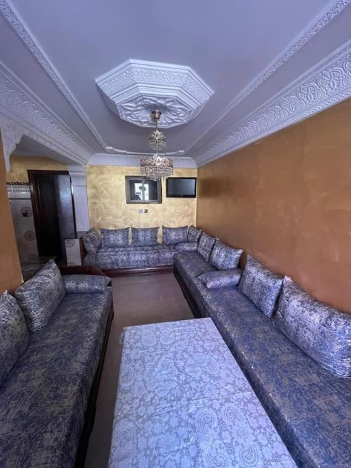 a large living room with couches and a ceiling at Fully equipped ground floor apartment in Safi