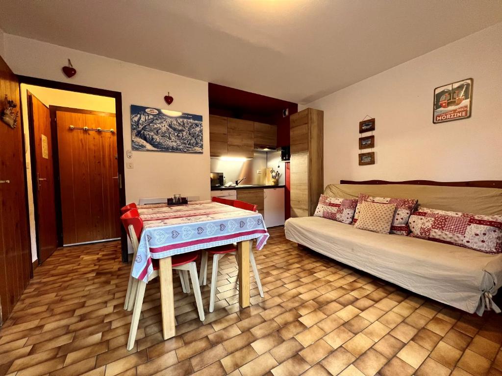 モルジヌにあるEdelweissのテーブルとベッド1台付きの部屋、キッチンが備わるアパートメントです。