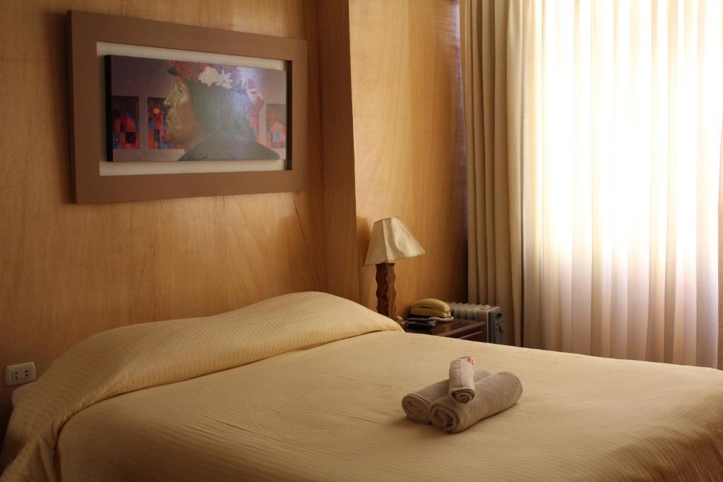 Postel nebo postele na pokoji v ubytování Kaaro Hotel El Buho