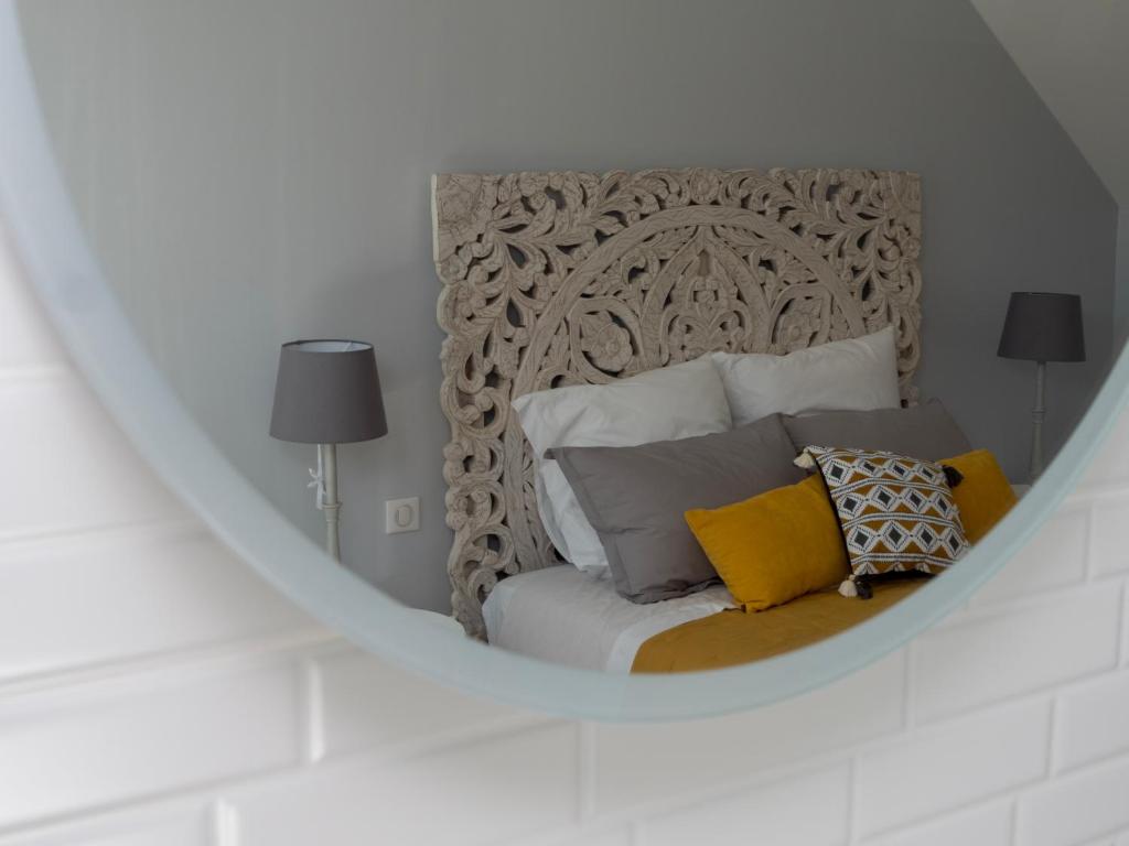 a bedroom with a bed with a large headboard at Gite Oliveira&#39;s in Ury