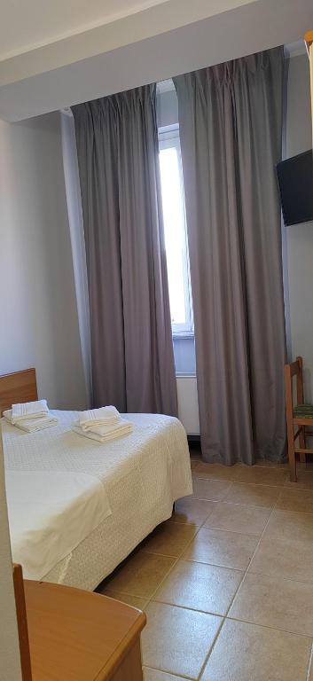 A bed or beds in a room at Hotel Nuovo Rondò
