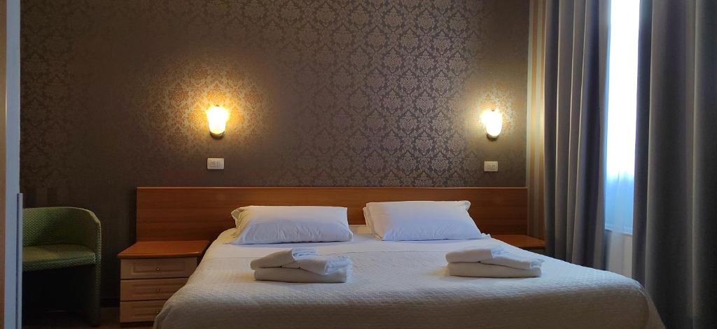 Hotel Nuovo Rondò في سيستو سان جيوفاني: غرفة نوم عليها سرير ووسادتين