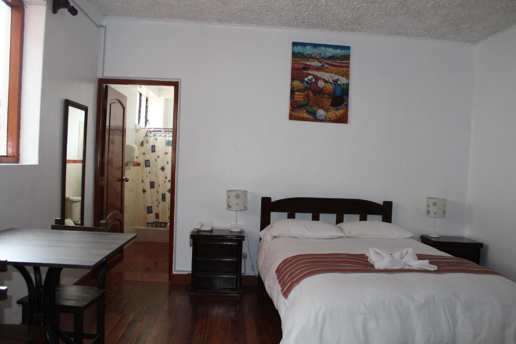Postel nebo postele na pokoji v ubytování KAARO HOUSE CUSCO