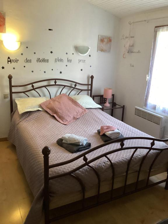 a bedroom with a bed with two towels on it at 196 rue des moulins in Vachères