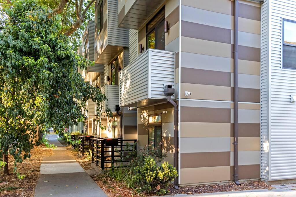 a building with a balcony and a sidewalk at Luxurious Brownstone Retreat - Walk to DT/Golden1 in Sacramento