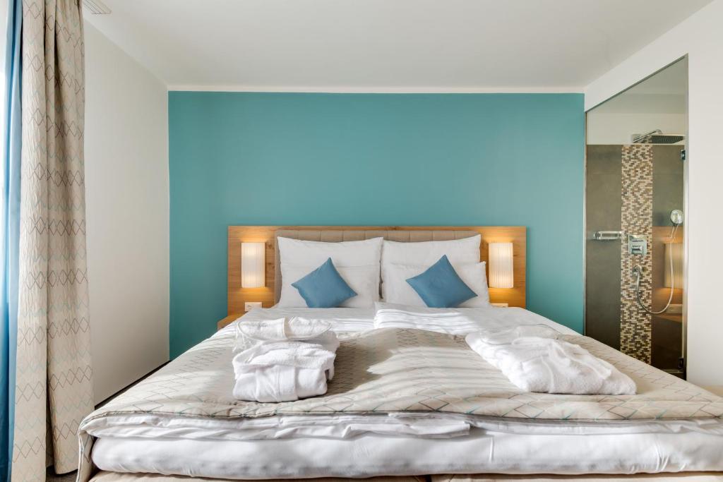Postel nebo postele na pokoji v ubytování R&R Residenzen Aparthotel
