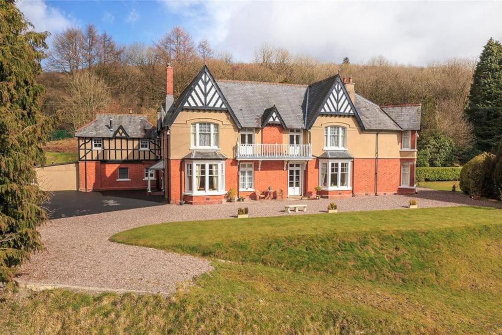 a large brick house with a large yard at Country Mansion - Private Annexe in Llanwrda