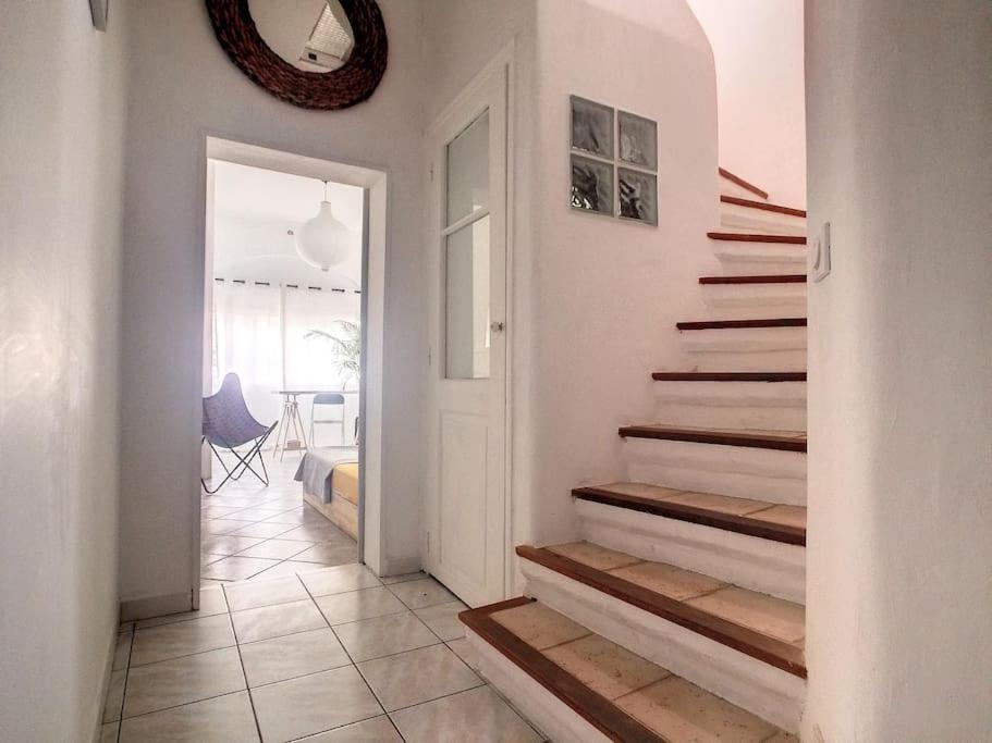 a hallway with stairs leading to a bedroom at Rare maison à 50m de la plage. Grande terrasse vue mer. in Palavas-les-Flots