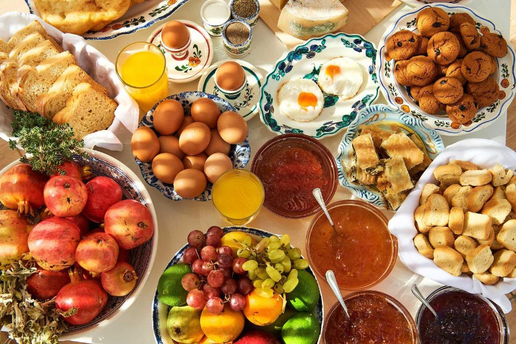 a table topped with lots of plates of food at Perigiali in Skiros