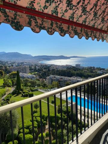 a balcony with a view of a swimming pool at NICE BAIE DES ANGES in Nice