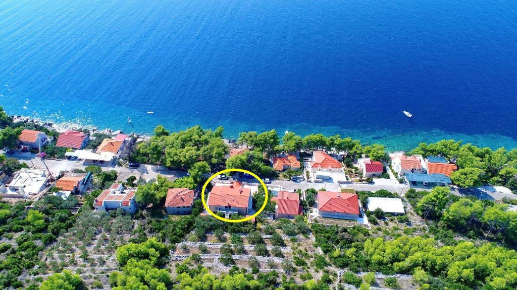 an aerial view of a house with a yellow circle at Seaside Apartments Markota in Blato