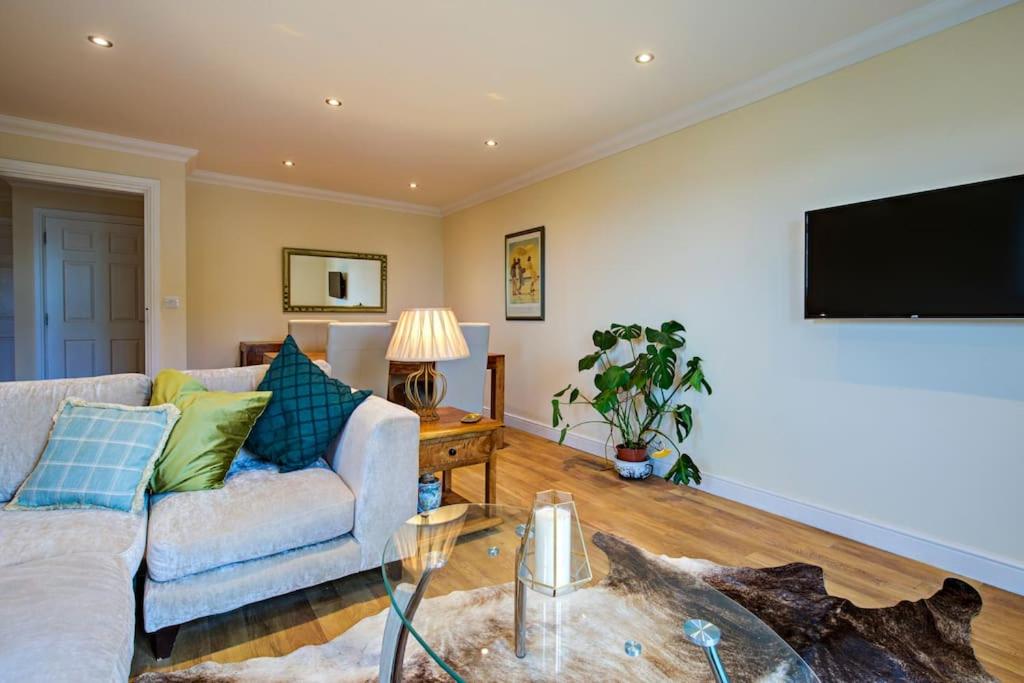 a living room with a couch and a tv at Inglewood Apartment, Ingleton, Yorkshire Dales National Park, Famous 3 Peaks and Near The Lake District Pet Friendly in Ingleton