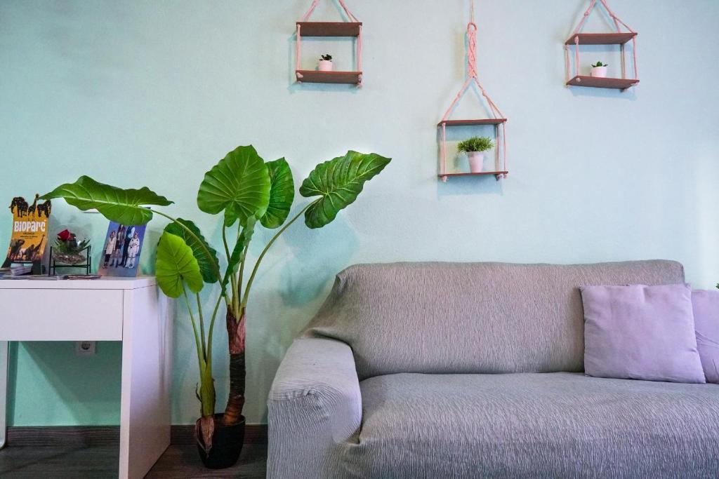 a living room with a couch and a table and plants at Bioparco Apartment in Valencia