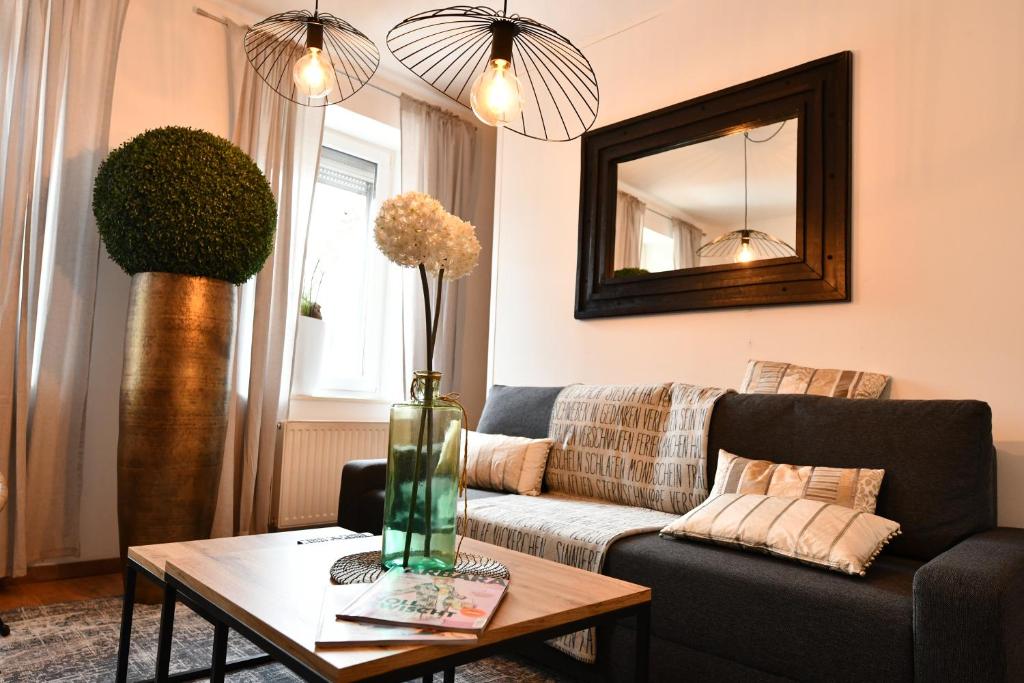 a living room with a couch and a table at Heimat Floral Ferienhaus in Wadgassen