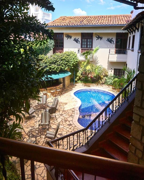 a balcony with a pool and chairs and a building at Hotel Plaza Copan in Copán Ruinas
