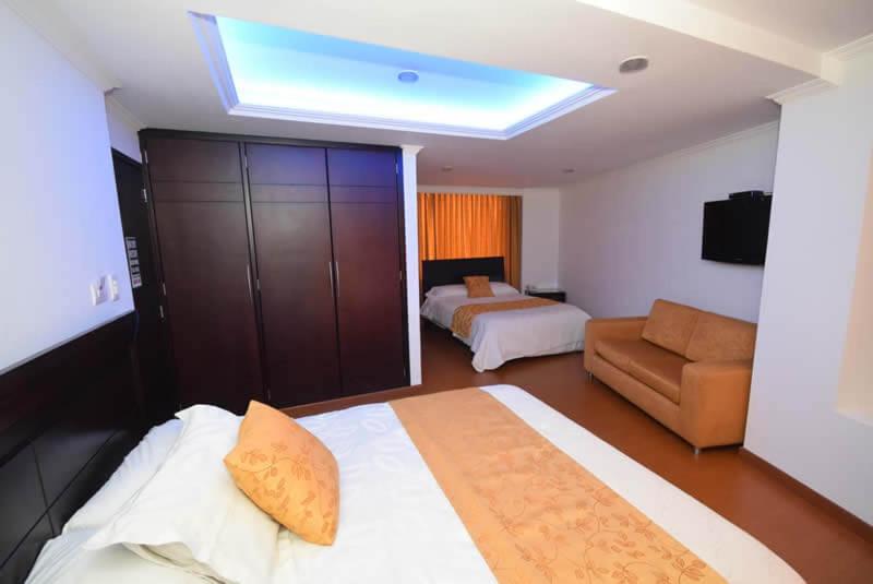 a hotel room with a bed and a couch at HOTEL ZAFIRO PLAZA in Tunja