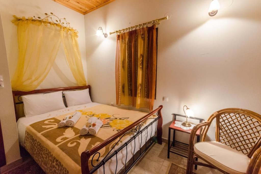 a bedroom with a bed with a table and a chair at Pelion Maisonette in Tsagarada