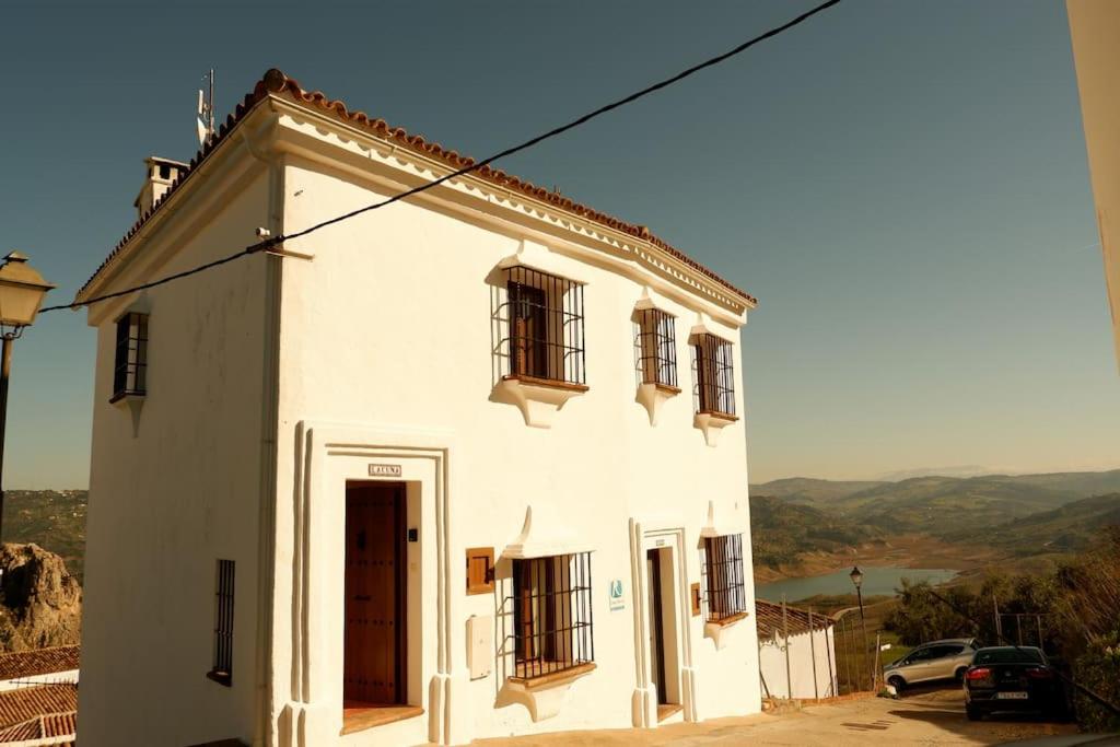 a white building with windows on the side of it at Casa mirador Atalaya de Zahara in Zahara de la Sierra