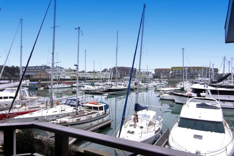 a bunch of boats are docked in a marina at Le loft-boat in Deauville