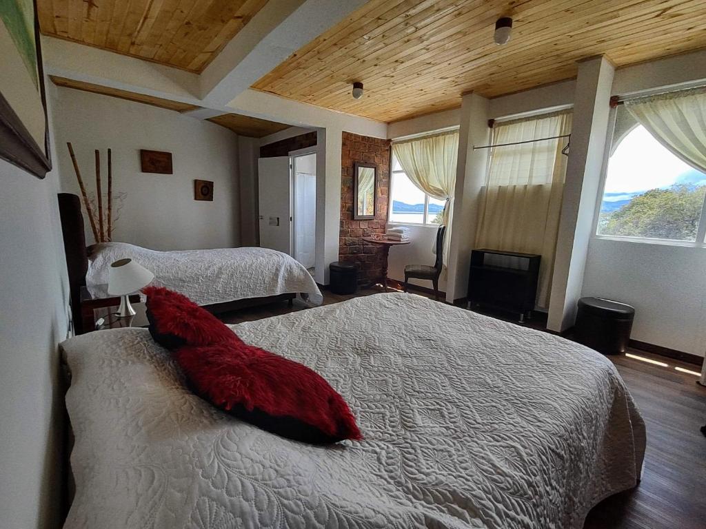 Postel nebo postele na pokoji v ubytování Refugio Génesis habitaciones Lago de Tota