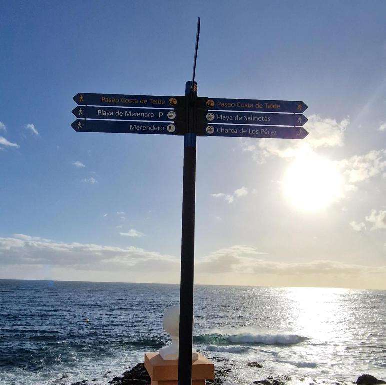 a street sign on the beach near the ocean at La Casita de la Charca in Melenara