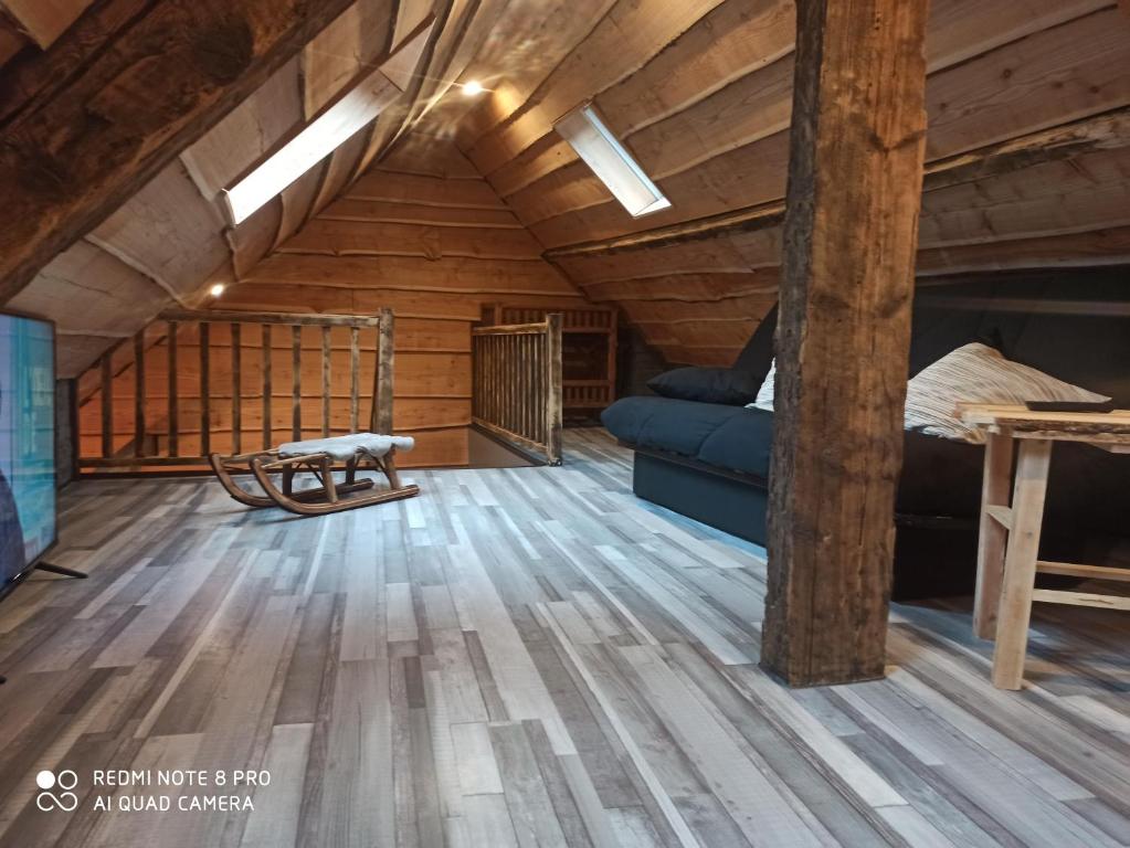 a room with a bed and a couch in a attic at Appart Chalet hyper centre in Cauterets