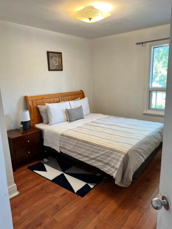 a bed in a bedroom with a wooden floor at appartement avec 2 chambres in Quebec City