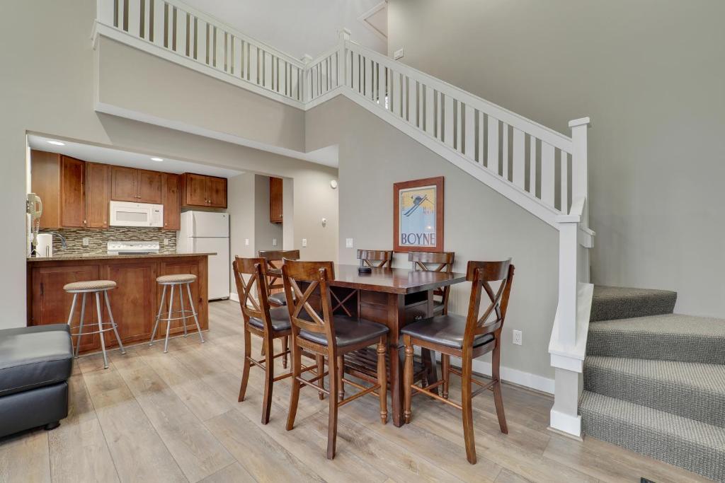 a kitchen and dining room with a table and chairs at 728 Disciples Village Condo in Boyne Falls