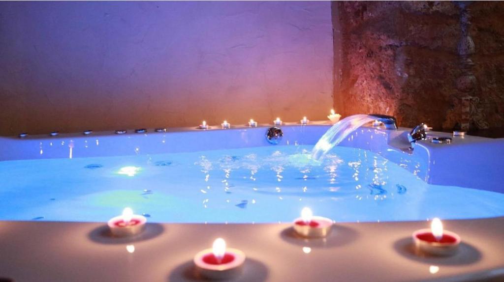 a pool with candles in it with a fountain at Experience Museum in Agrigento