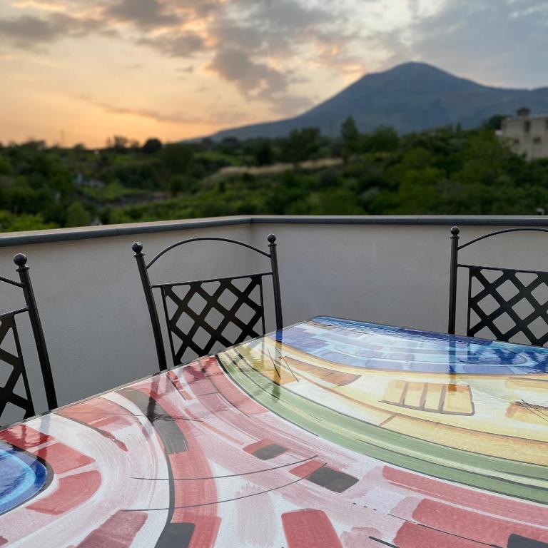 a table on a balcony with a view of a mountain at Villa Manzo relais -Pompei Vesuvius in Boscotrecase