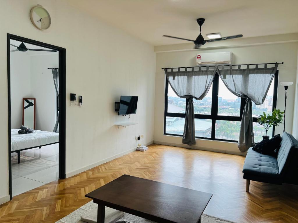ein Wohnzimmer mit einem Sofa und einem großen Fenster in der Unterkunft Cozy Private Studio Apartment with View in Shah Alam