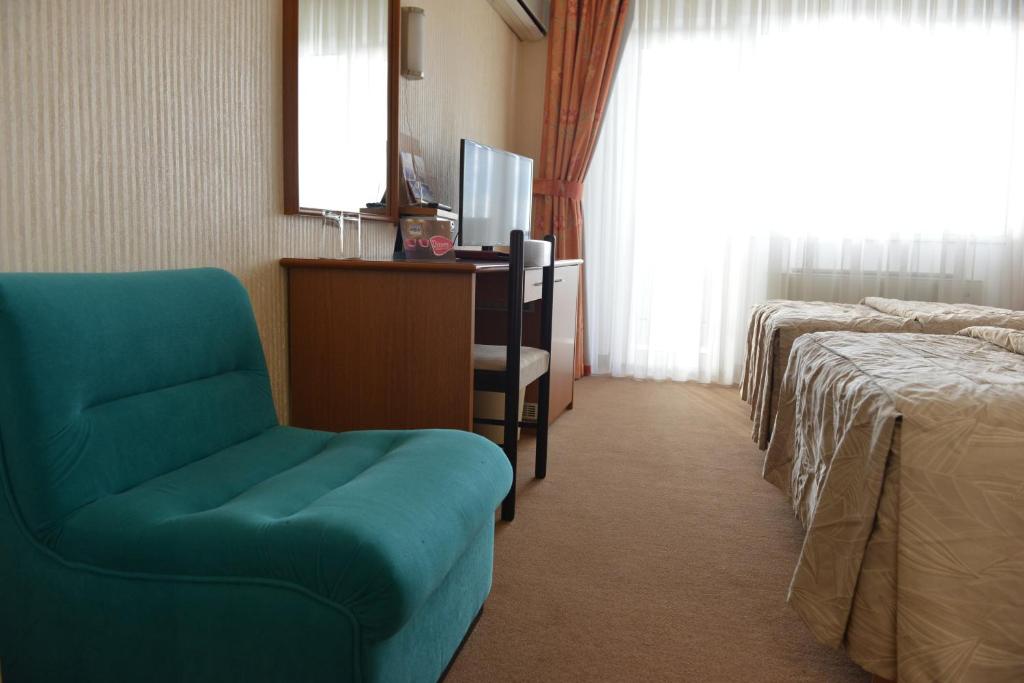 Postel nebo postele na pokoji v ubytování Hotel Bellevue