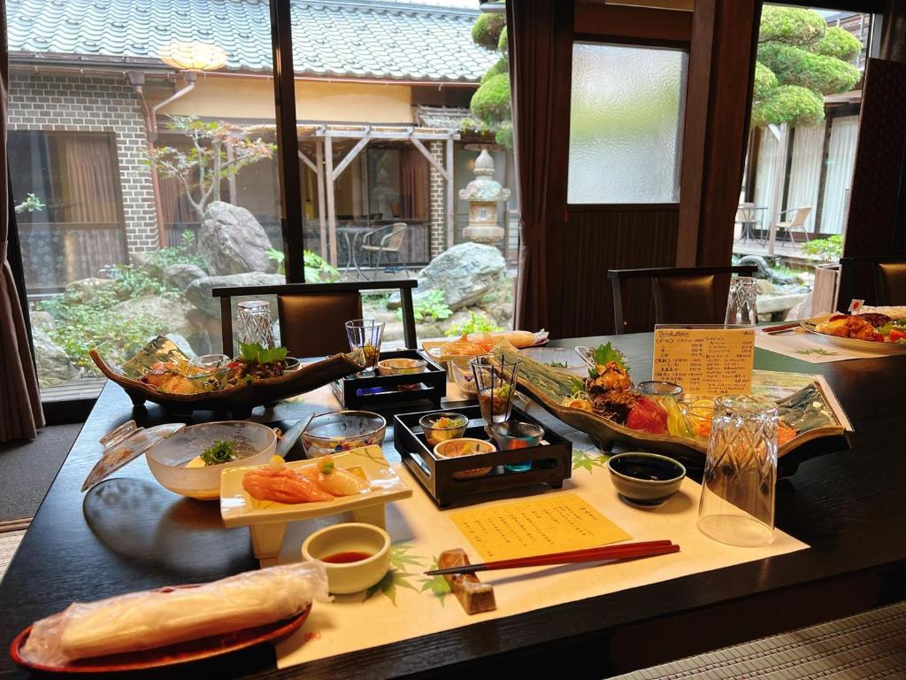 a table with many different types of food on it at Japanese style hotel Morigen in Kyotango