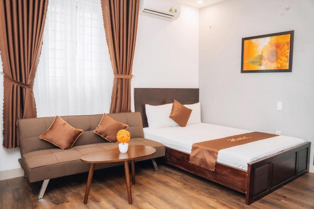 Postel nebo postele na pokoji v ubytování King Hotel Da Nang