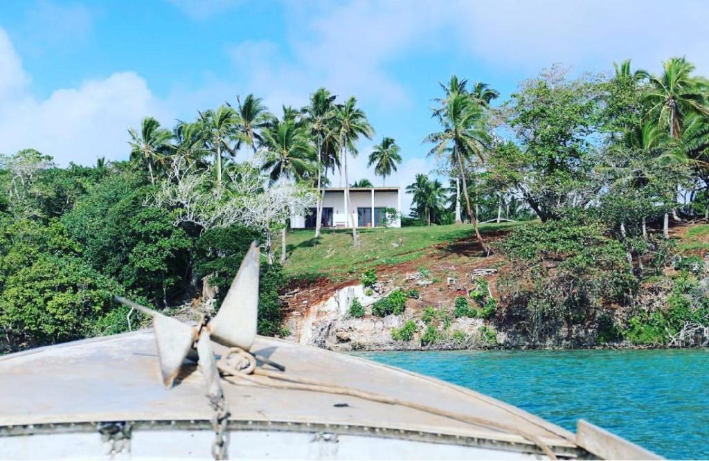 a boat in the water in front of a house at Saralee’s House in Toula