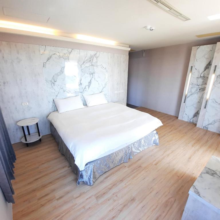 Postel nebo postele na pokoji v ubytování Lanhiwan Inn