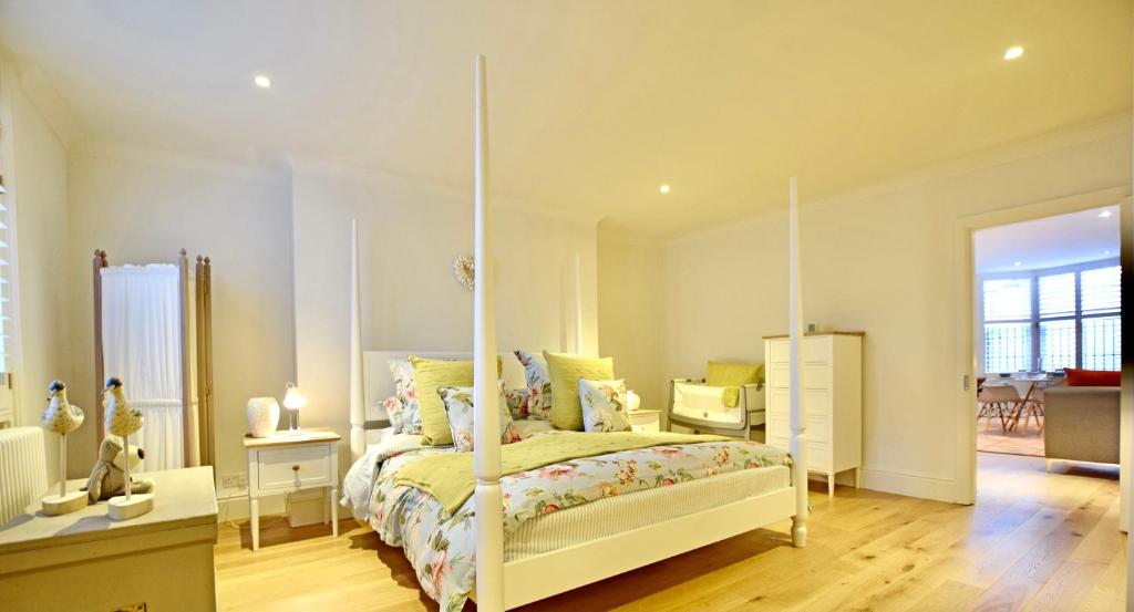 a bedroom with a white bed with a canopy at BRIGHTON BEACH APARTMENT Parking Free & EV Port in Brighton & Hove