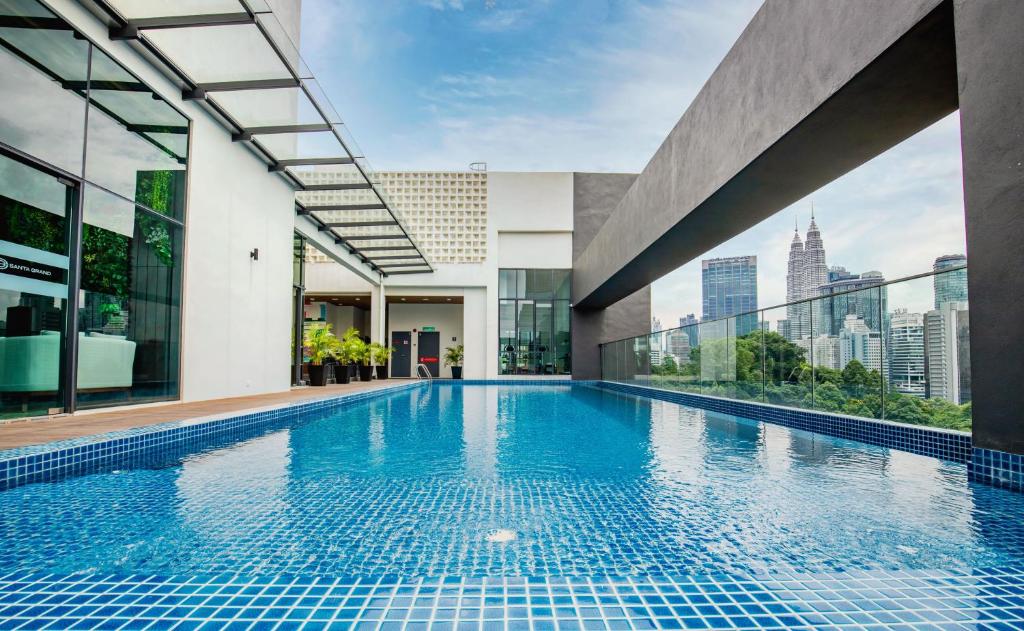 A rooftop-style pool with Kuala Lumpur landmarks in the background.