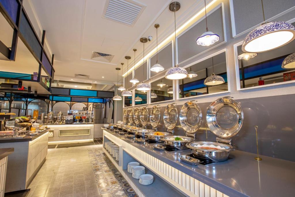 A buffet counter lined with prepared dishes and serving equipment.
