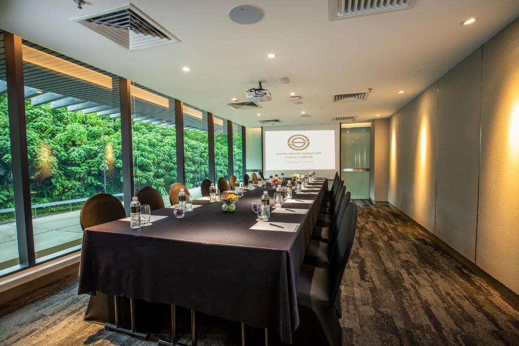 A long conference table in a windowed meeting room.