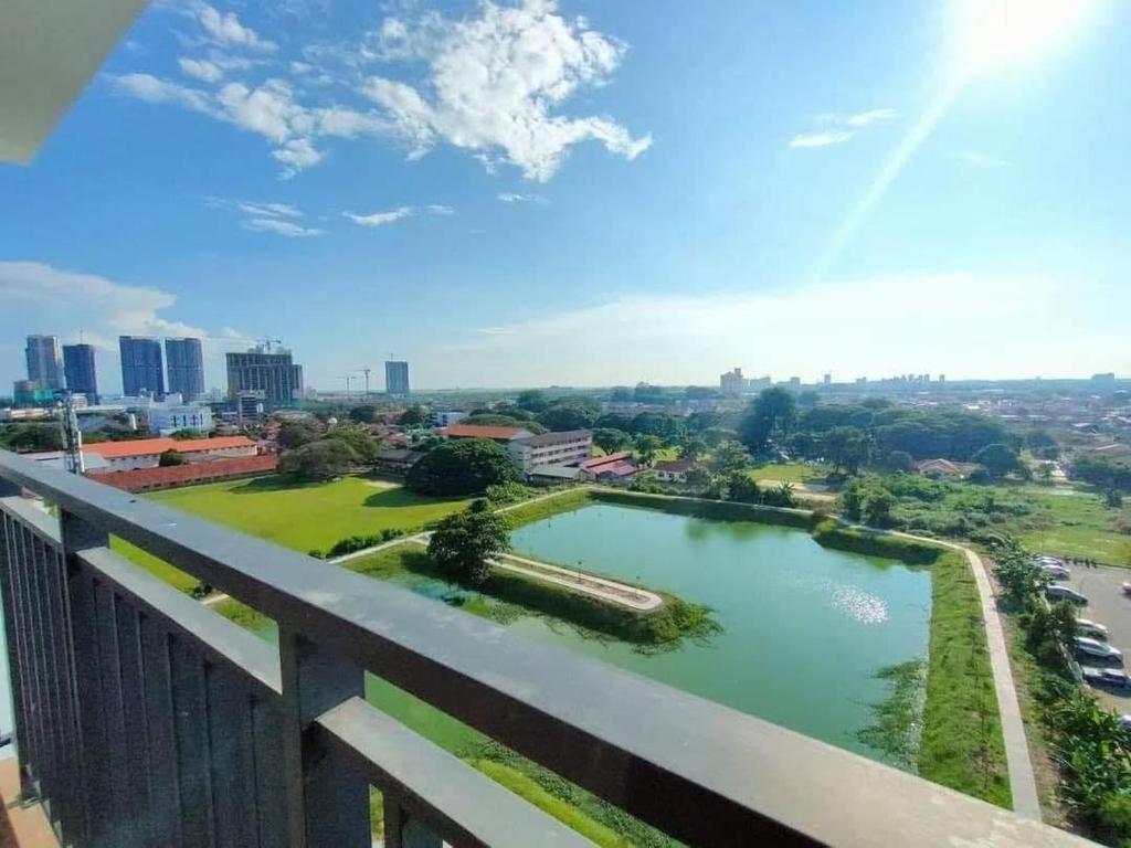 a view from the balcony of a building with a pond at MyNest1103A@SweetHome in Melaka