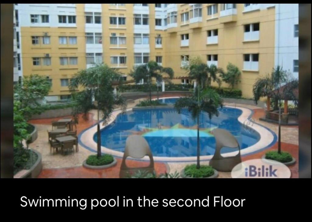 a swimming pool in the second floor of a building at 2 Bedroom Condo Unit in Manila