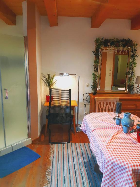 a room with a table and a chair and a mirror at Sonnleit'n Zimmer 7 in Abtenau