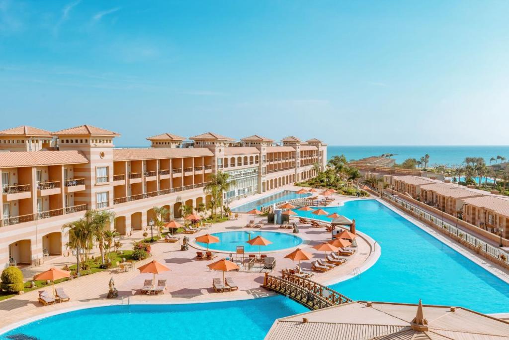 an aerial view of a resort with two pools and umbrellas at Coral Sea Beach and Aqua Park in Ain Sokhna